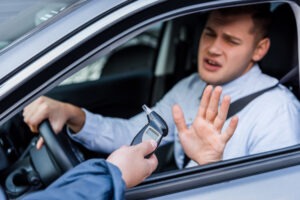 man getting reprimanded for exceeding the legal alcohol limit in California