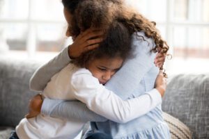 A woman hugging her daughter after a deadly accident. You can get compassionate support from a Riverside fatal truck accident lawyer.