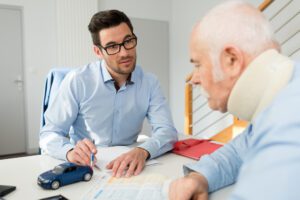 An injured man wearing a neck brace discussing his case with an experienced car accident lawyer in San Francisco.