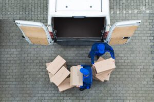 Several men working out of a FedEx truck. A Riverside FedEx truck accident lawyer can help you after a collision.