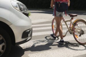 A negligent driver is moments away from hitting a girl crossing the street with a bike. A pedestrian accident lawyer in Riverside can help injured victims build a strong case.