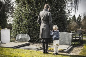 A mother and son grieve a lost loved one before meeting with a Santa Ana wrongful death lawyer.